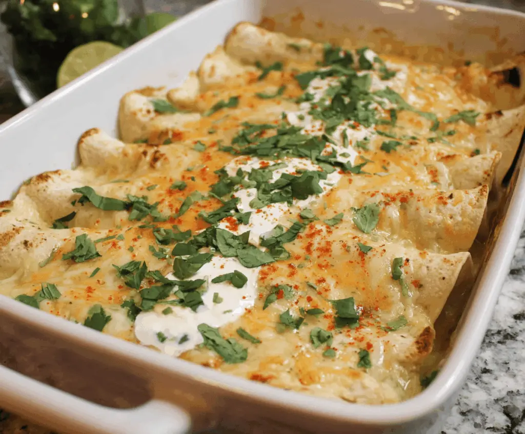 Delicious low carb white chicken enchiladas topped with melted cheese and fresh cilantro, served on a plate