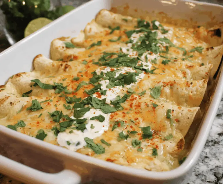 Delicious low carb white chicken enchiladas topped with melted cheese and fresh cilantro, served on a plate