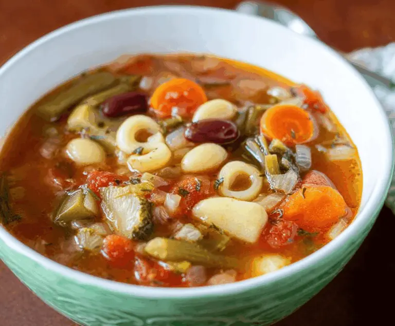 A bowl of fresh Olive Garden-style vegetable soup featuring colorful diced vegetables and herbs in a savory broth, perfect for a healthy, hearty meal.