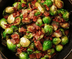 Delicious crispy bacon-wrapped Brussels sprouts garnished with fresh herbs, ready to serve as a savory appetizer or side dish.