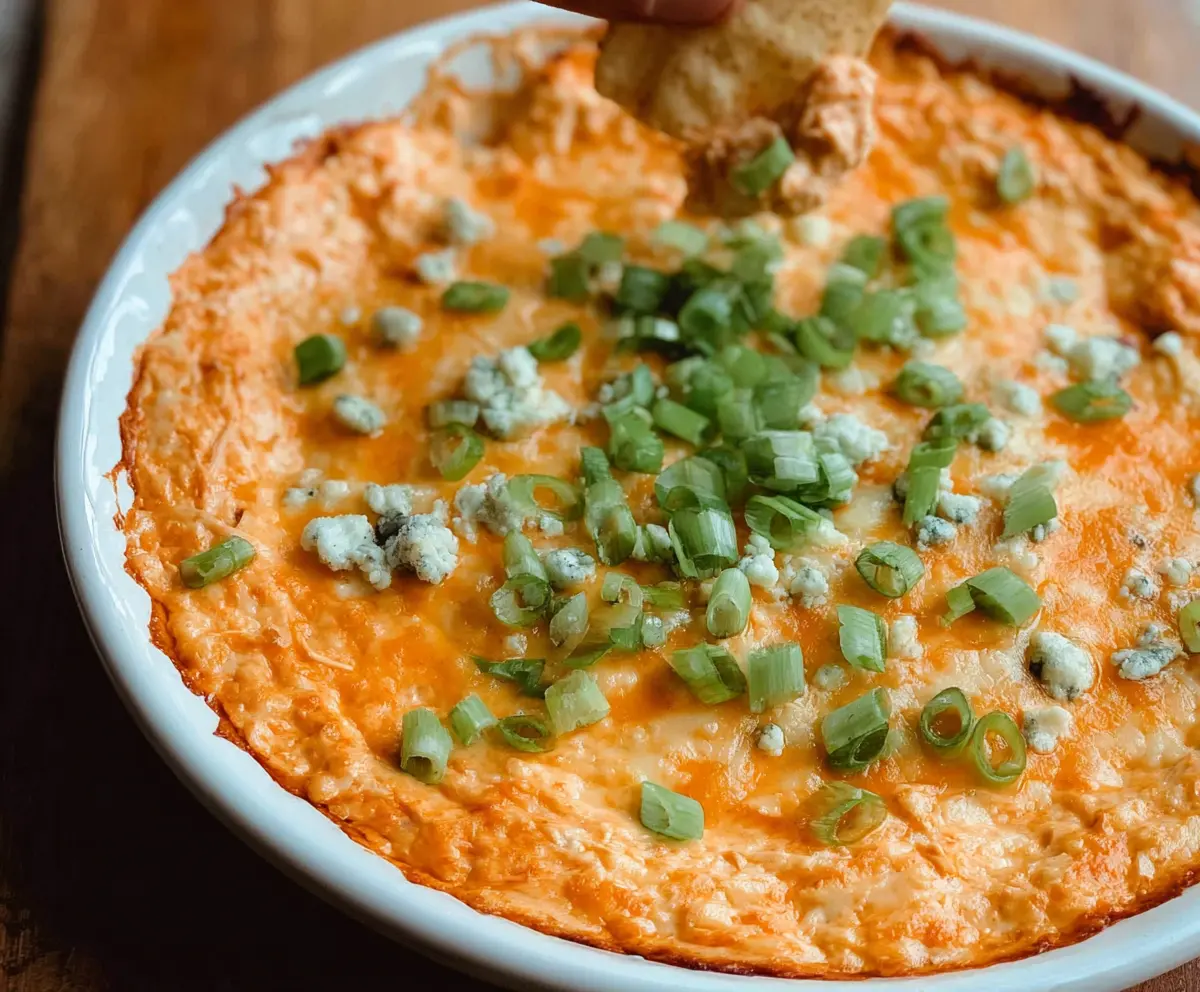 Creamy Buffalo Chicken Dip served with celery sticks and tortilla chips, perfect for parties and game day snacks.