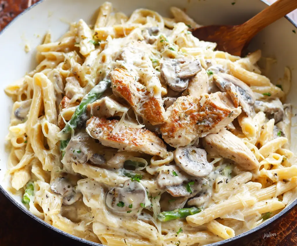 Creamy Chicken Alfredo pasta served on a white plate garnished with parsley.