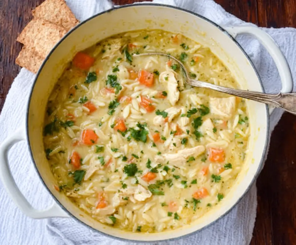 Creamy Chicken Orzo Winter Soup in a bowl with fresh herbs