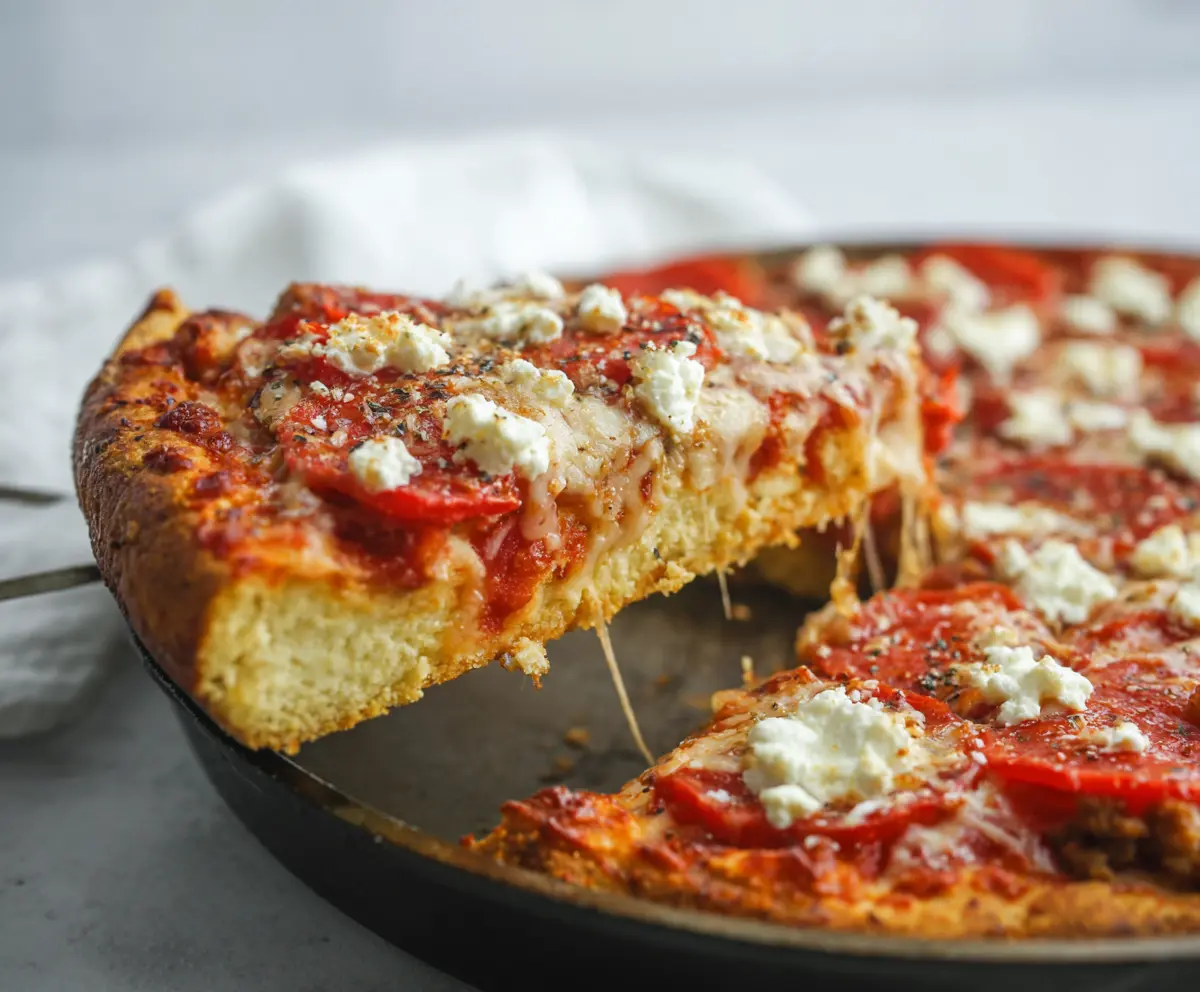 High protein cottage cheese pizza topped with fresh vegetables and melted cheese, perfect for a healthy snack or meal.