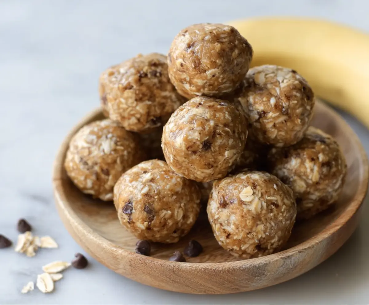 Close-up of homemade Peanut Butter Banana Protein Balls on a wooden surface, showcasing their delicious texture and healthy ingredients.