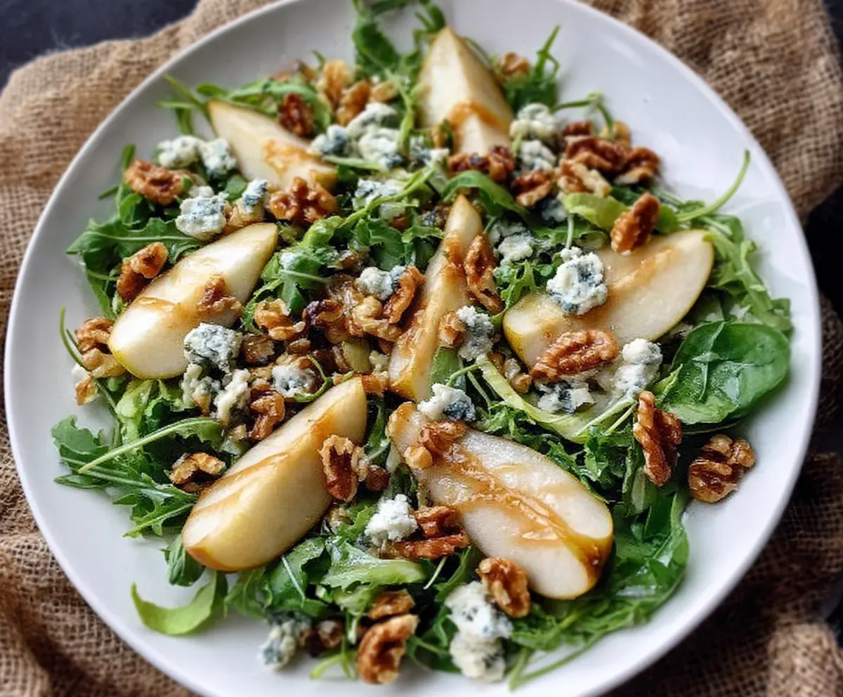 Fresh Pear and Gorgonzola Salad topped with Candied Walnuts, perfect for a light and savory meal.