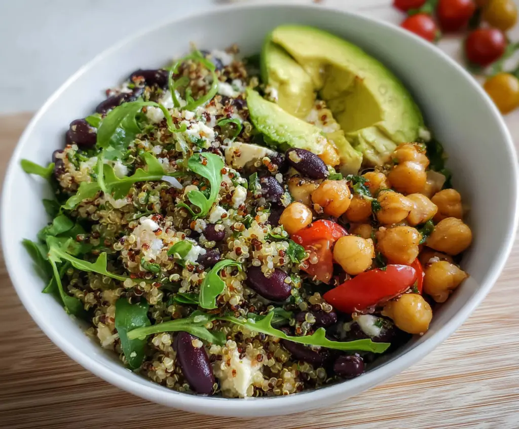 Healthy quinoa bowl with ripe avocado and seasoned chickpeas, perfect for a nutritious meal.