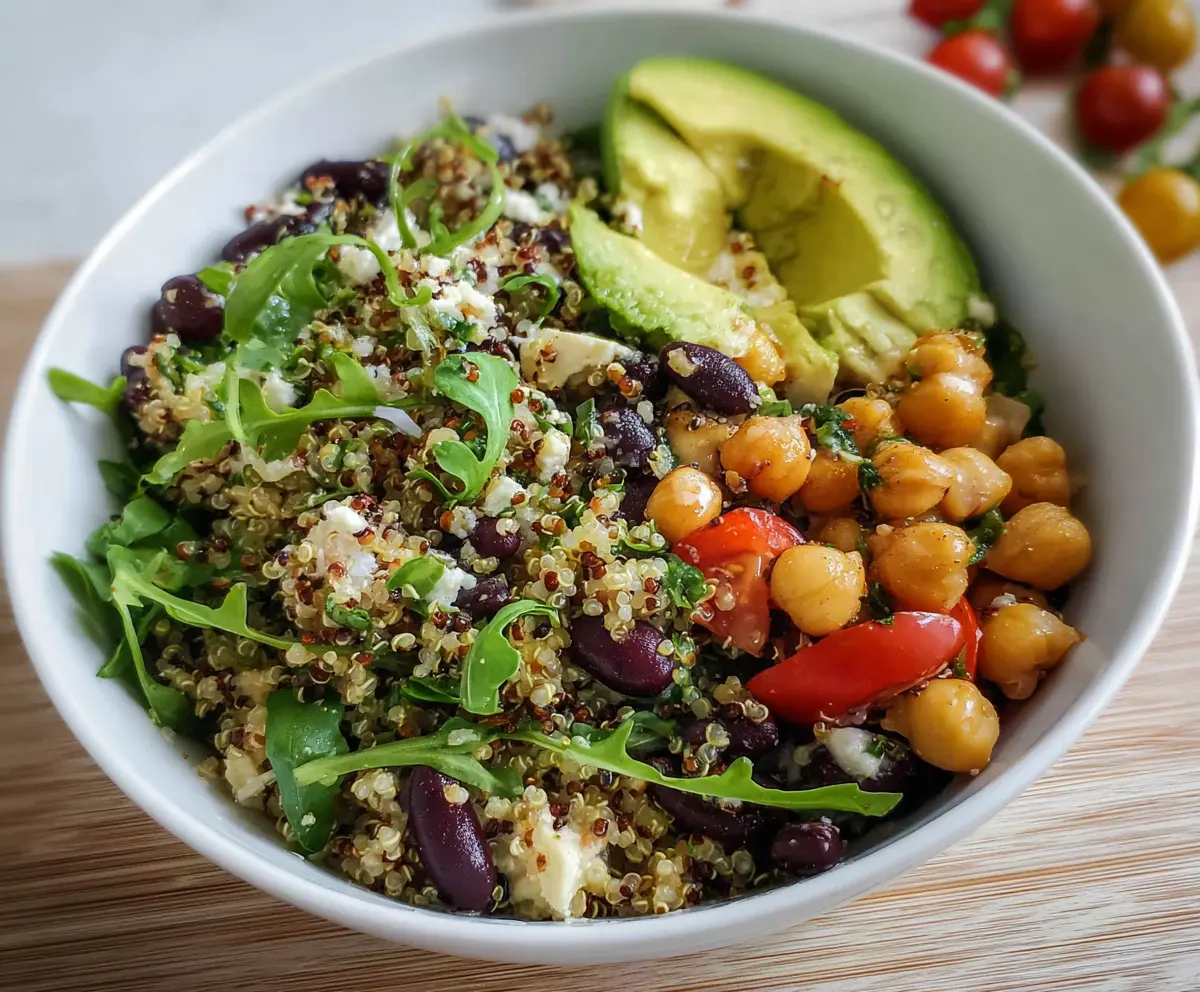 Healthy quinoa bowl with ripe avocado and seasoned chickpeas, perfect for a nutritious meal.