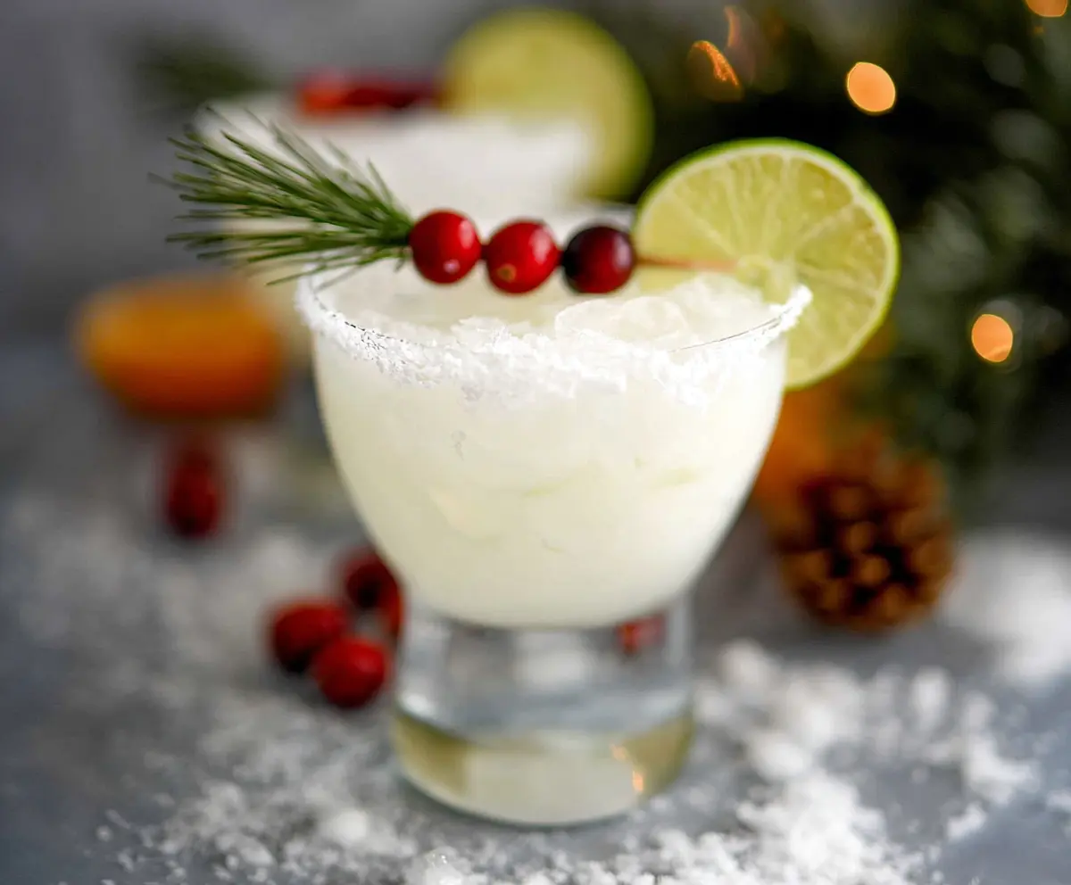 Refreshing White Christmas Margarita in a stylish glass garnished with a lime wedge.
