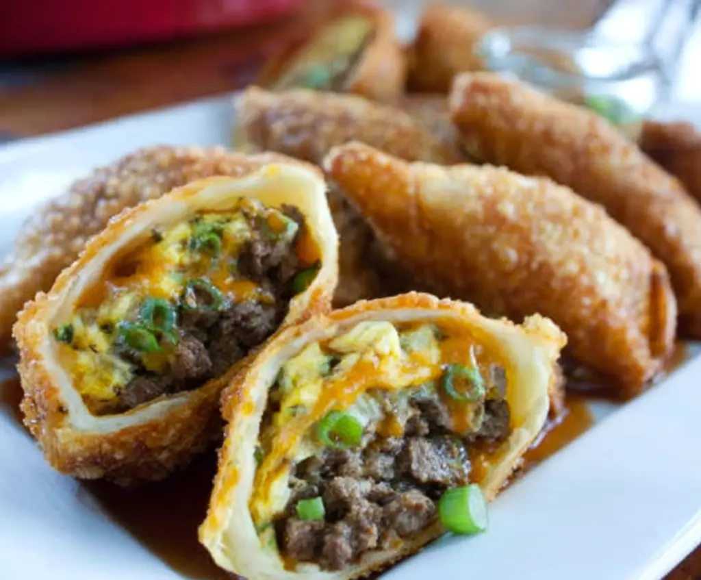 Delicious Philly Cheesesteak Egg Rolls filled with tender beef, melted cheese, and crispy fried wrapper.