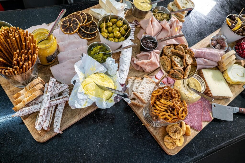 A sideboard with small bowls of pretzels, olives, and cut vegetables ready for arriving guests.