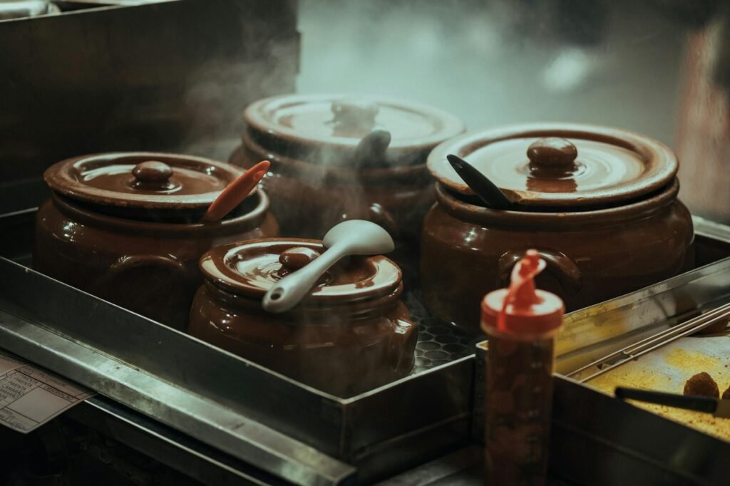 Soup simmering uncovered in a stock pot as steam rises
