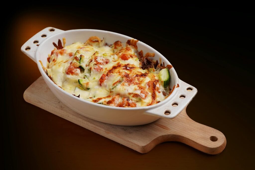 A casserole with a crisp browned top and visible vegetables