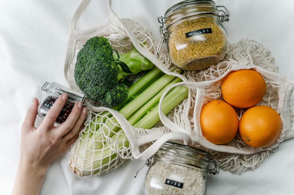 A grocery receipt and notebook beside meal prep ingredients and reusable containers