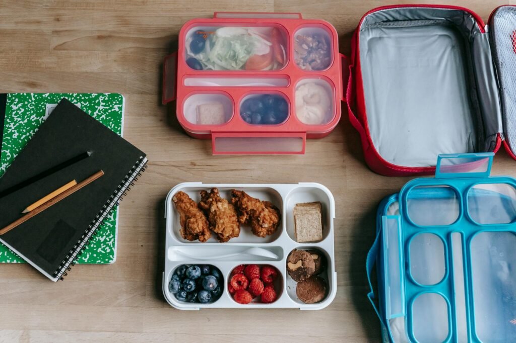 An insulated lunch bag packed with gel packs and a divided lunch container