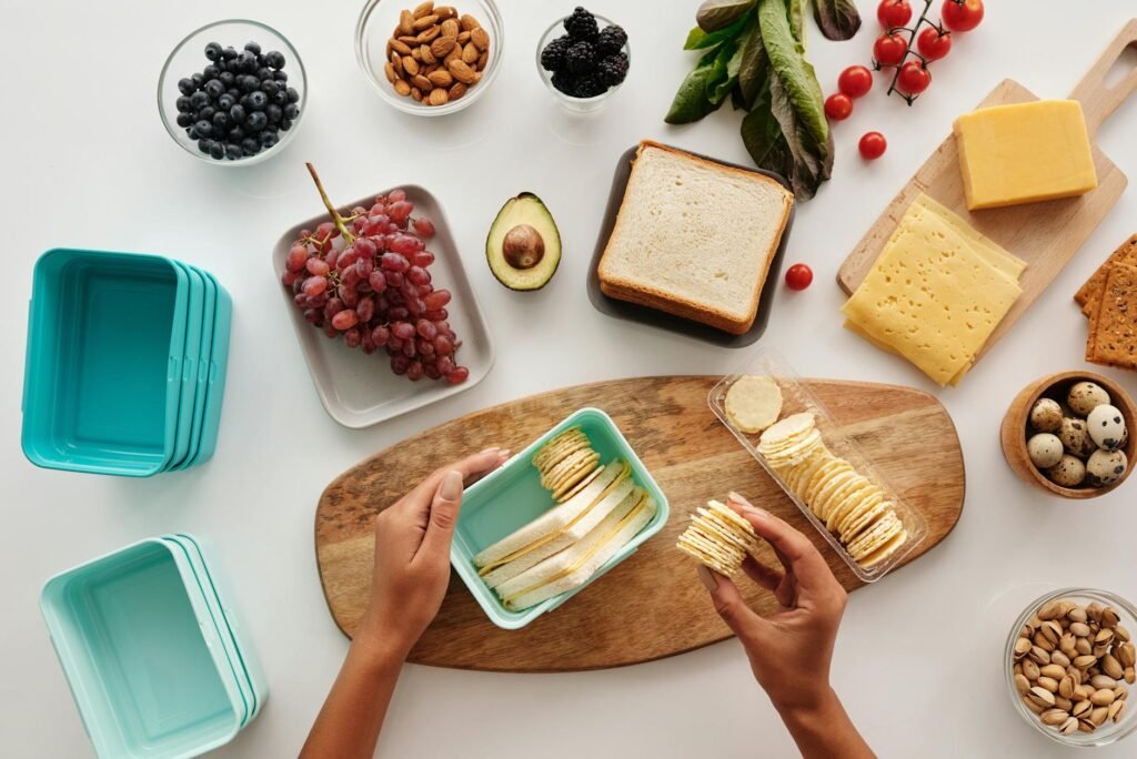 An insulated lunch bag packed with ice packs, fruit, and lunch containers