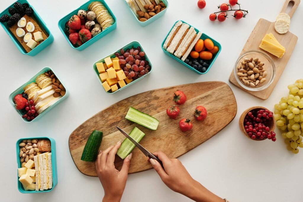 Whole strawberries, bagels, cheddar, cucumber, and yogurt set out for brunch prep