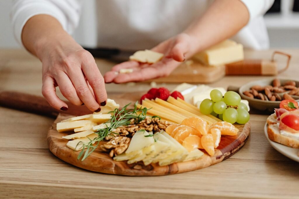 A host refilling a small brunch platter from chilled ingredients in the refrigerator
