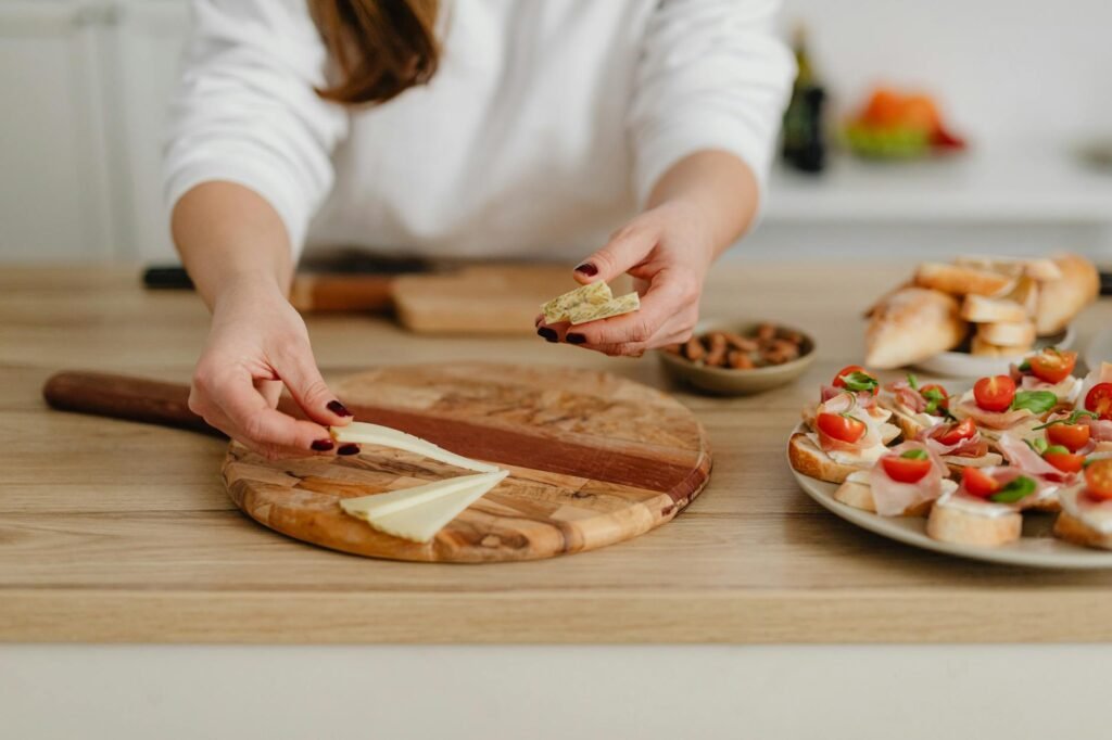 An organized kitchen counter with labeled snack platters, a timer, and chilled backup containers.