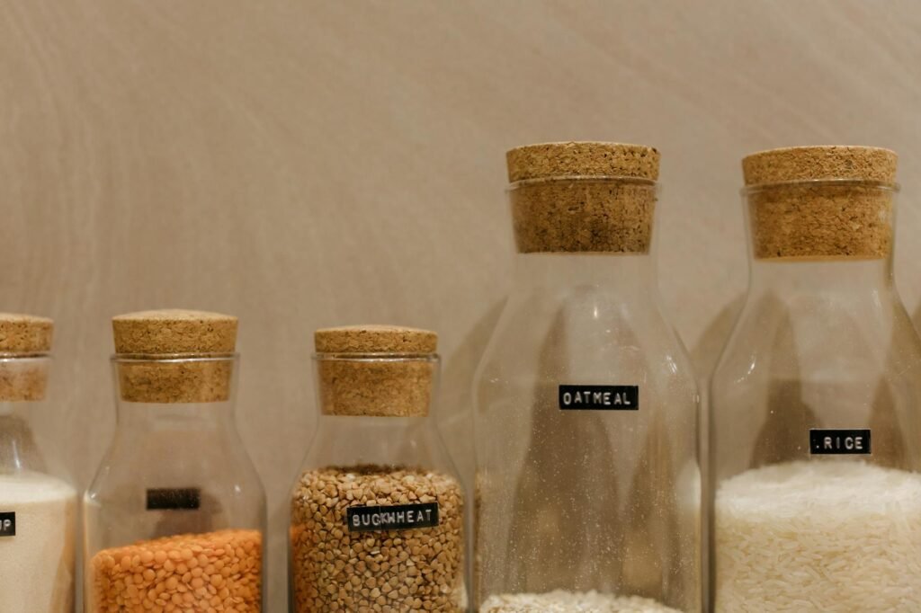 Covered containers of leftover vegetables and grains stored neatly in a refrigerator
