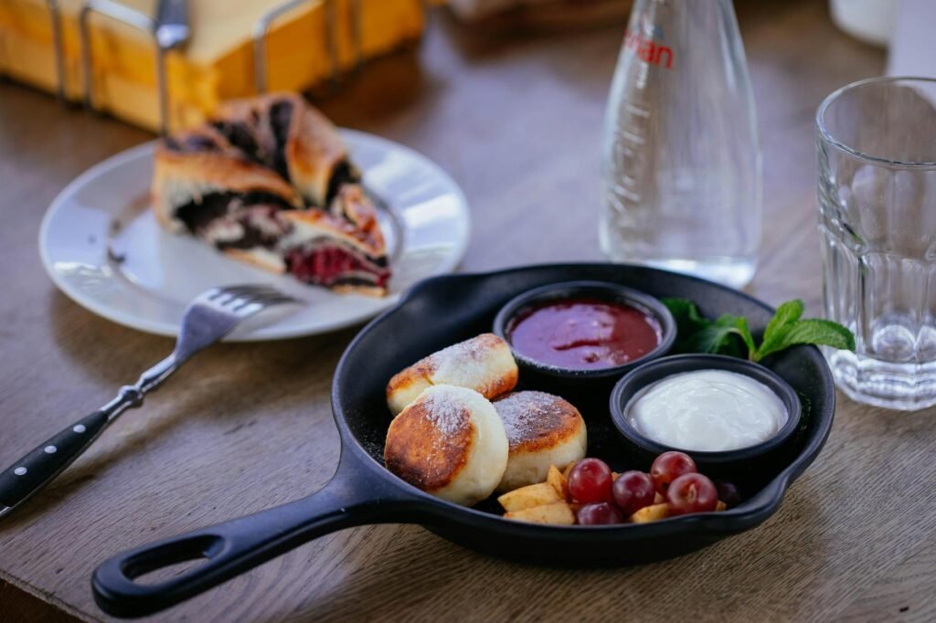Puff pastry, berries, cream cheese, and preserves arranged on a kitchen counter