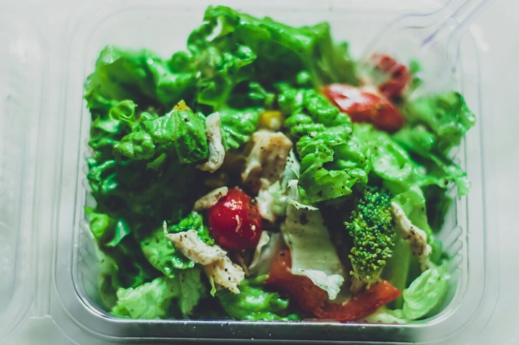 A neatly organized freezer with containers and a ready-to-cook backup dinner.